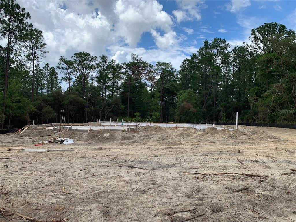 A concrete foundation slab for a new house sits on a cleared, sandy lot — 4807 W PINTO LOOP, BEVERLY HILLS, FL