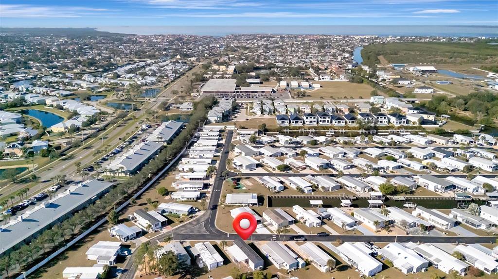 This aerial view shows a residential neighborhood of manufactured homes with a red location pin — 105 W SAINT JOHNS WAY, APOLLO BEACH, FL