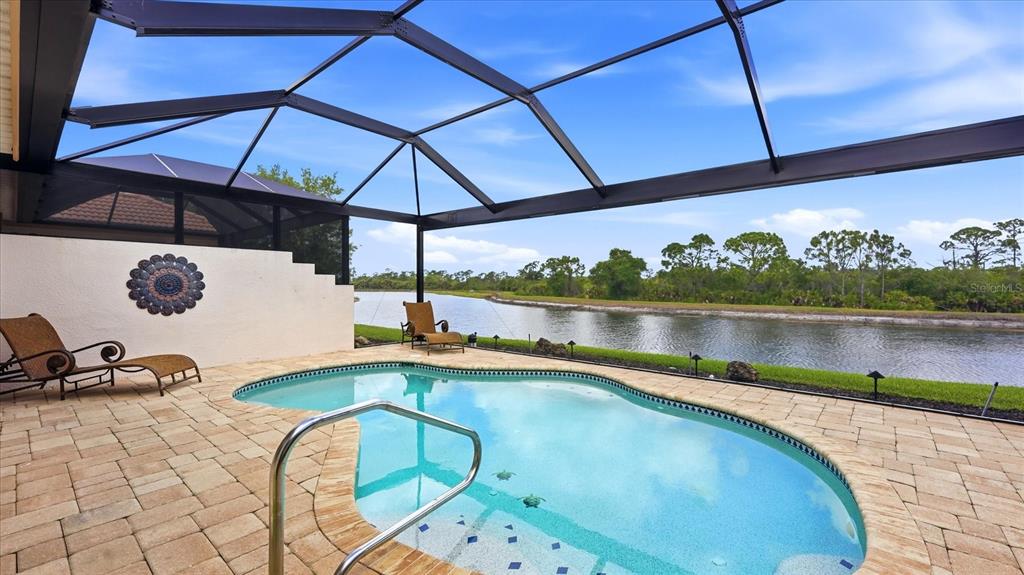 An aerial view shows a single-story house with a tile roof and a two-car garage — 13177 CREEKSIDE LANE, PORT CHARLOTTE, FL