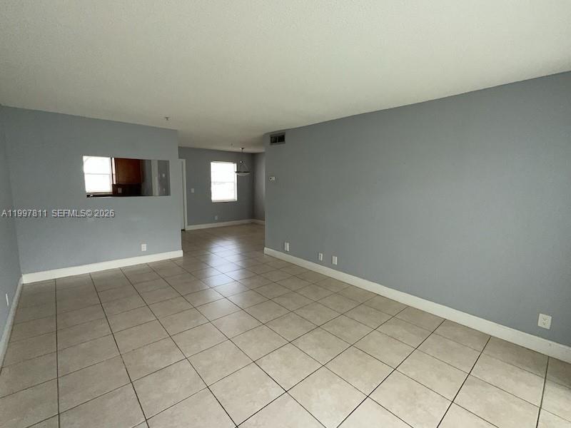 An empty room features light gray walls, beige tile flooring, and a rectangular wall cutout — 4251 NW 5th St # 108, Plantation FL 33317, PLANTATION, FL