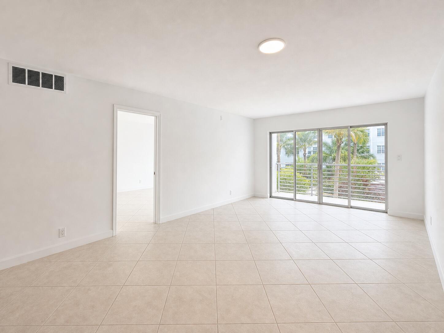 An empty room with beige tile flooring, white walls, and a sliding glass balcony door — 1541 S Ocean Boulevard # 219, Pompano Beach FL 33062, POMPANO BEACH, FL