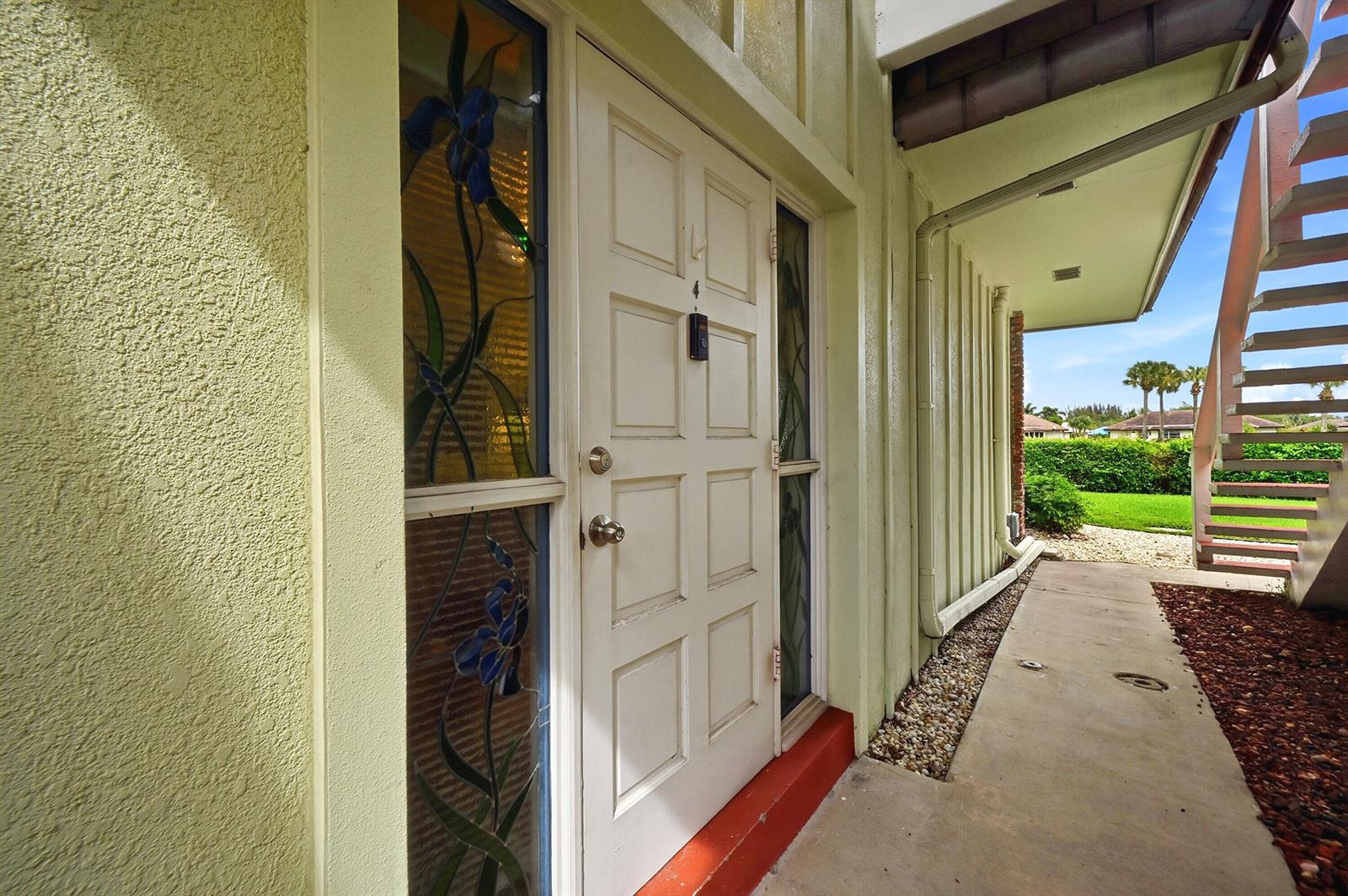 A bathroom features a walk-in shower, a white vanity, a toilet, and beadboard wall paneling — 324 Orange Tree Drive # 4, Atlantis FL 33462, ATLANTIS, FL