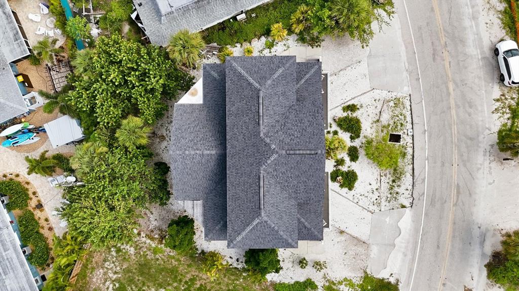 An aerial view shows a house with a gray shingled roof surrounded by landscaping — 1245 SHORE VIEW DRIVE, ENGLEWOOD, FL