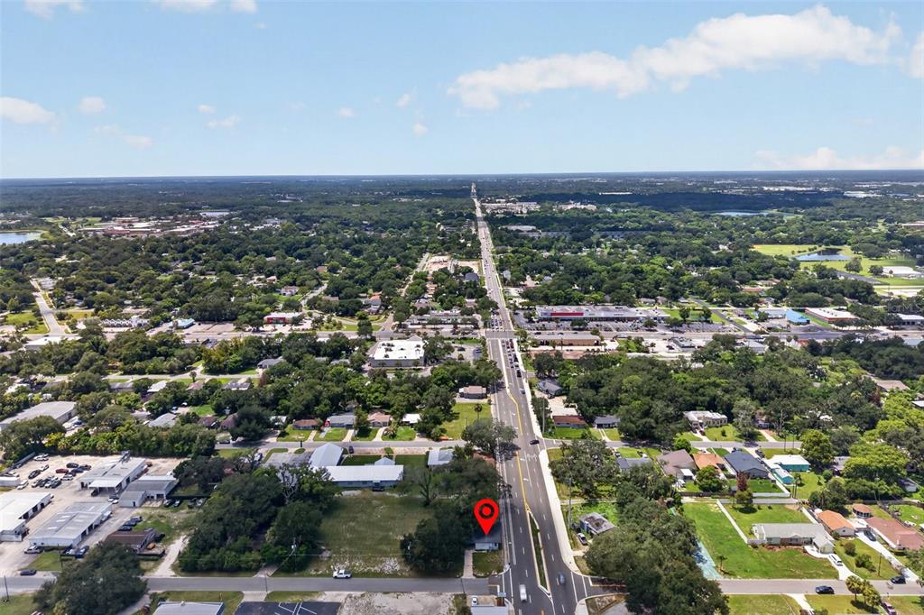 An aerial view shows a commercial property marked with a pin along a busy road — 2500 MYRTLE AVENUE, SANFORD, FL