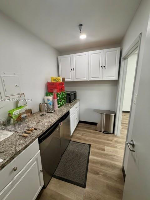 A small kitchen area features white cabinets, a granite countertop, and stainless steel appliances — 3108 NW 72nd Ave, Miami FL 33122, MIAMI, FL