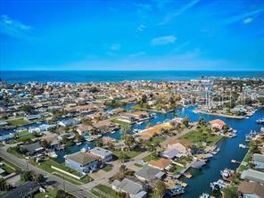 An aerial view of a coastal neighborhood with houses situated along interconnected canals — 6728 SEA RANCH DR, HUDSON, FL