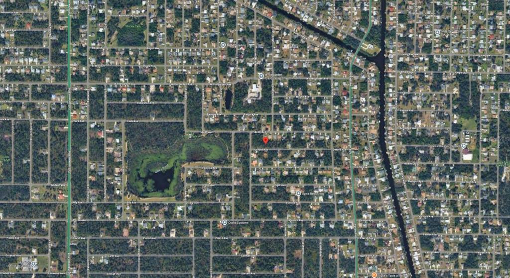 This is an aerial map view of a residential neighborhood with a red location marker — 18334 OXFORD AVENUE, PORT CHARLOTTE, FL