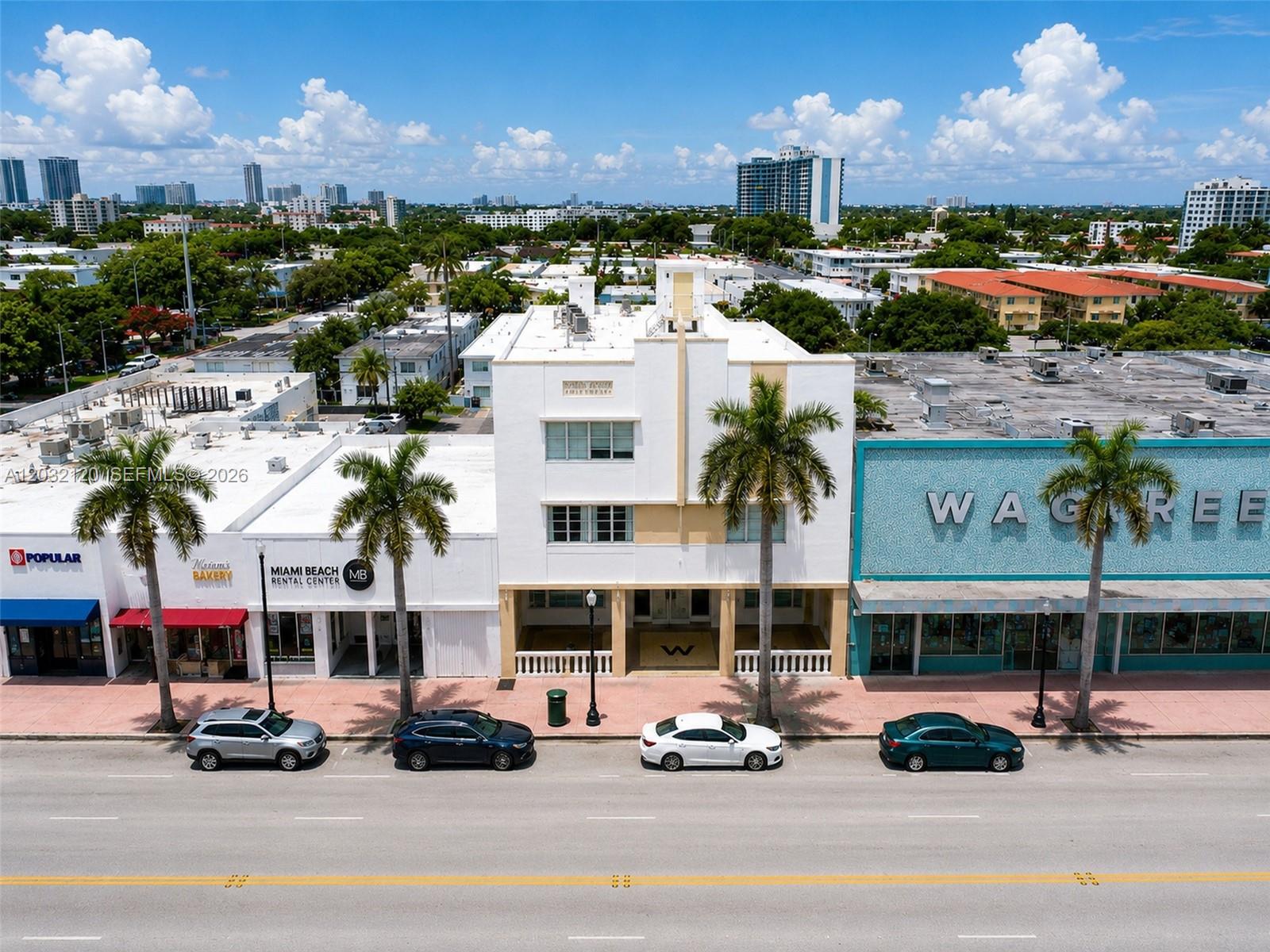 An aerial view shows a white Art Deco building flanked by storefronts along a street — 7326 Collins Ave # 203, Miami Beach FL 33141, MIAMI BEACH, FL