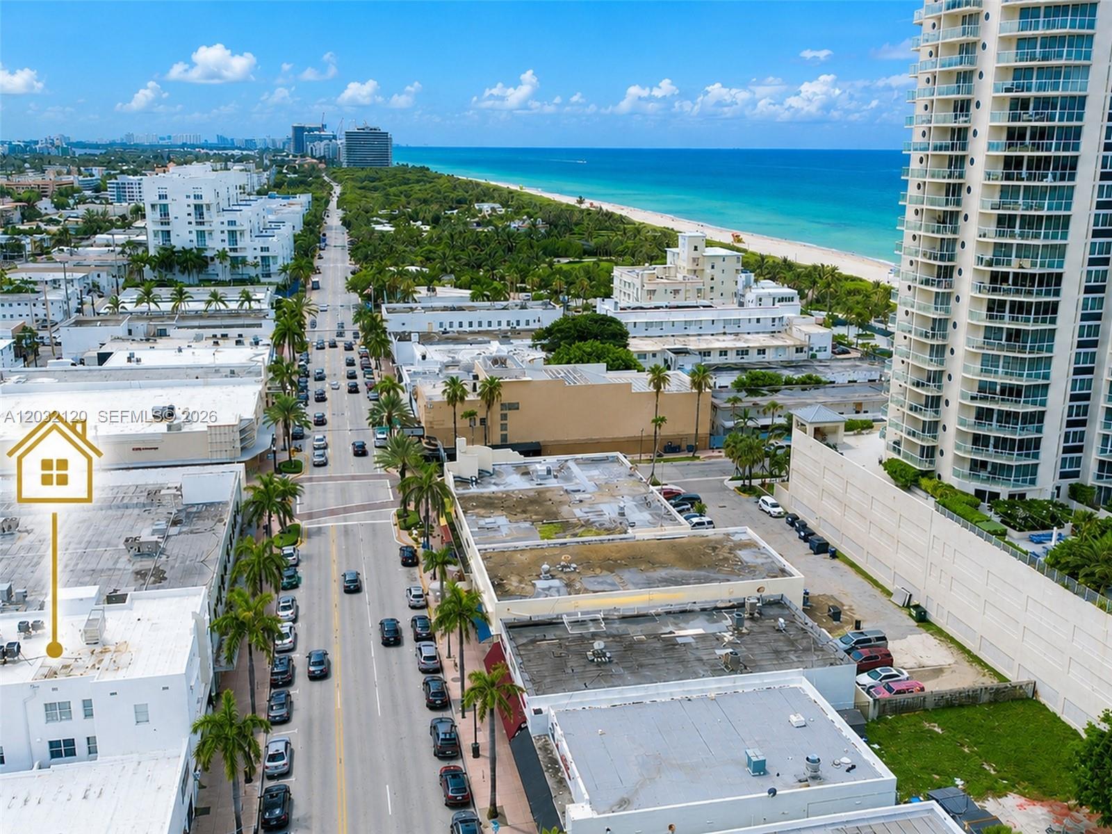 An aerial view shows a coastal city street lined with palm trees and buildings — 7326 Collins Ave # 203, Miami Beach FL 33141, MIAMI BEACH, FL
