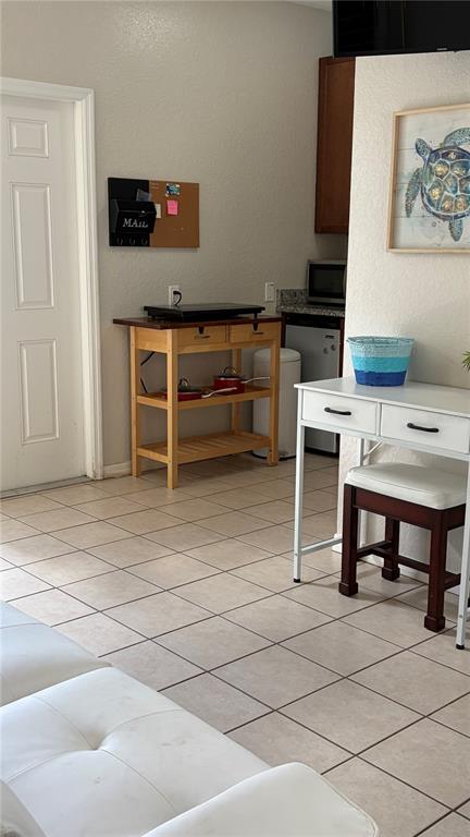 A kitchen area features a wooden cart, a white desk with a stool, and tiled flooring — 389 NOLANE LANE, POLK CITY, FL
