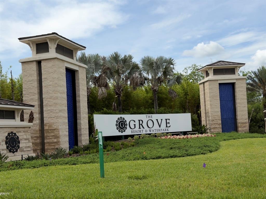 The entrance sign for The Grove Resort & Waterpark features two stone pillars and landscaping — 14501 GROVE RESORT AVENUE UNIT 3303, WINTER GARDEN, FL
