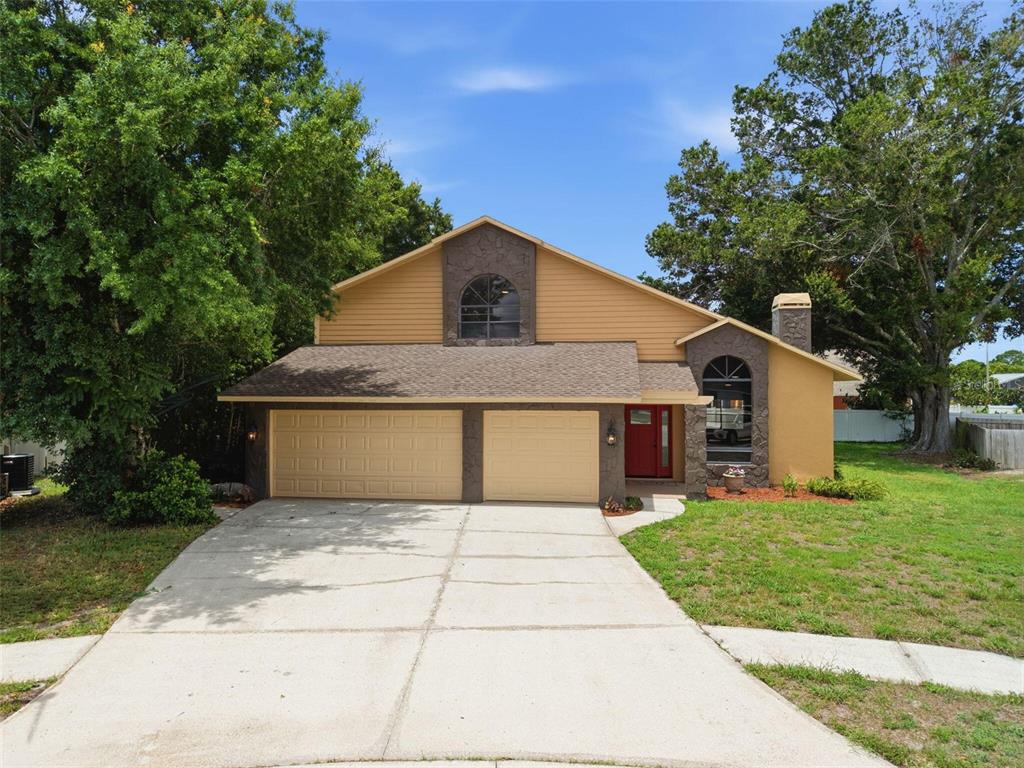 A screened-in patio features a swimming pool, a covered seating area, and beige siding — 5509 GANNETT COURT, NEW PORT RICHEY, FL