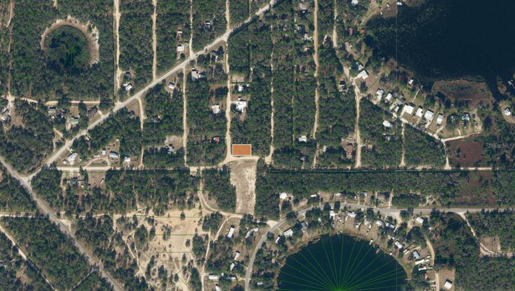 An aerial map view shows a rectangular lot highlighted in orange within a wooded area — TBD DOGWOOD DRIVE, INTERLACHEN, FL
