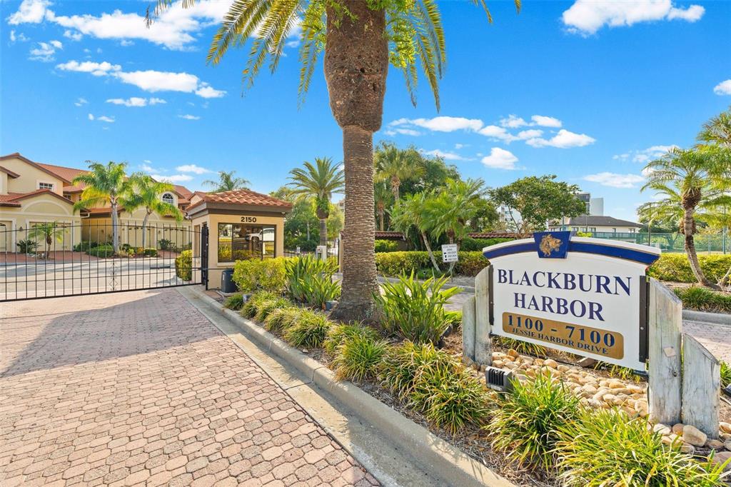 A gated entrance features a stone sign for Blackburn Harbor and a guardhouse — 6100 JESSIE HARBOR DRIVE UNIT 202, OSPREY, FL