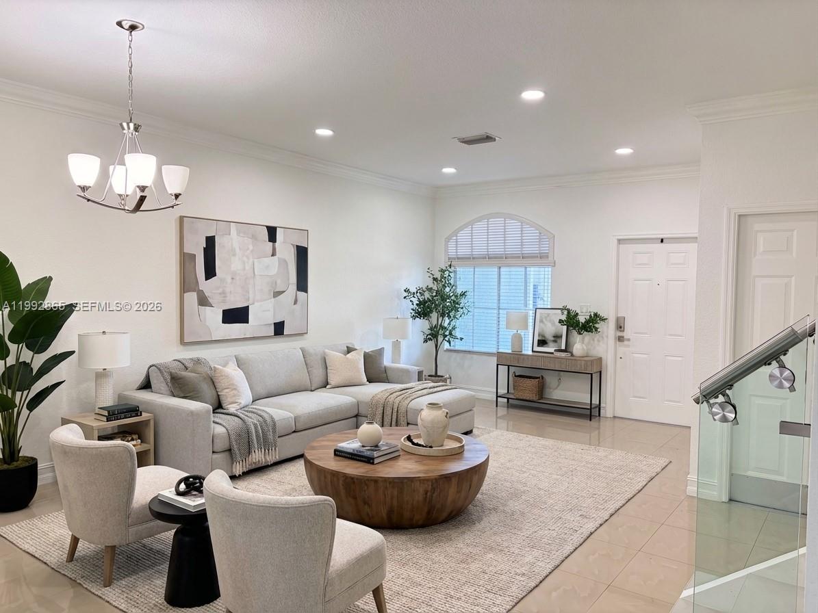 A modern living room features a sectional sofa, round wooden coffee table, and neutral decor — 14738 SW 22nd Ter, Miami FL 33185, MIAMI, FL