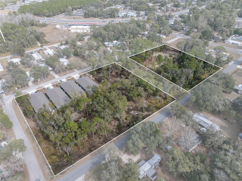 An aerial view shows two adjacent wooded lots, one containing a row of townhomes — 6408 W FLANDERS LANE, CRYSTAL RIVER, FL