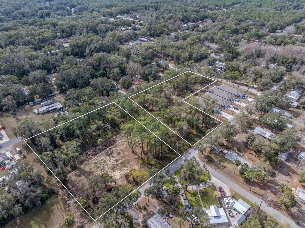 An aerial view shows two adjacent wooded lots outlined in white within a residential area — 6408 W FLANDERS LANE, CRYSTAL RIVER, FL