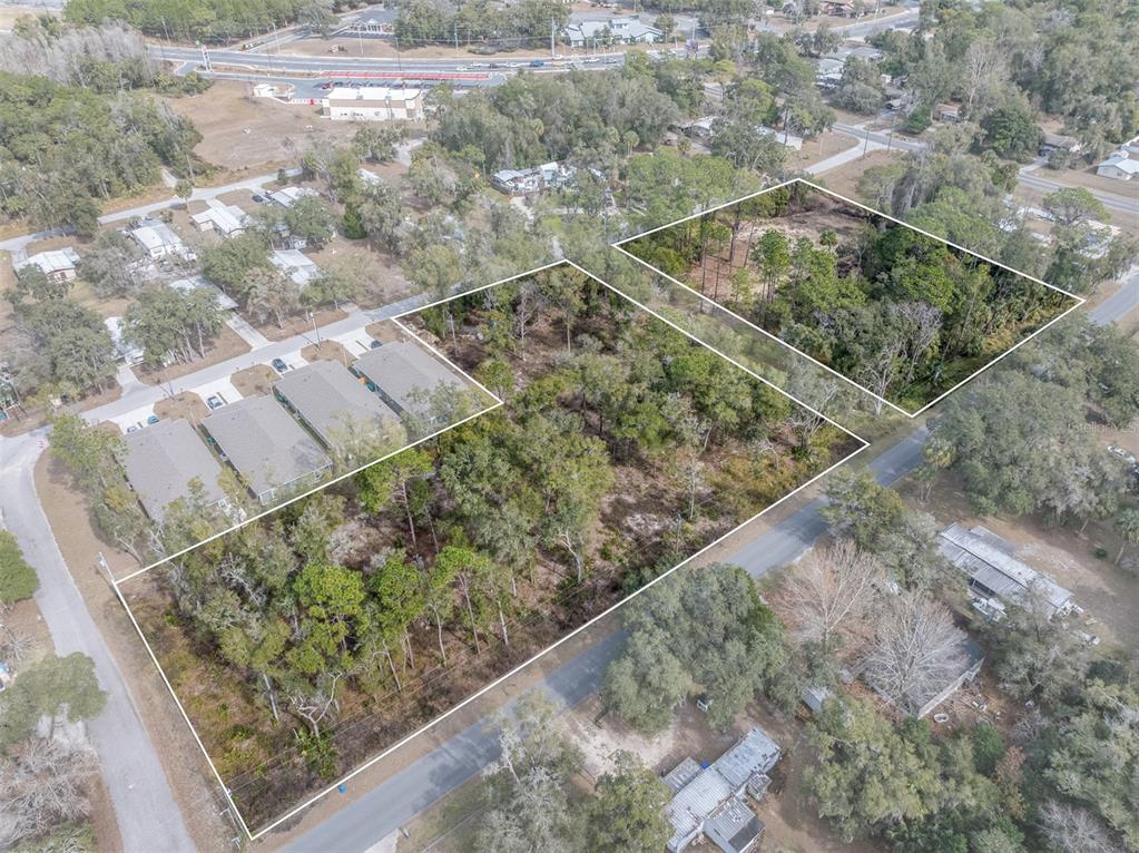 An aerial view shows two adjacent, undeveloped wooded lots outlined in white — 6408 W FLANDERS LANE, CRYSTAL RIVER, FL