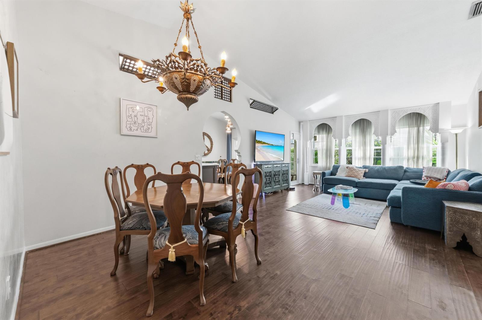 A dining area with a chandelier and a living room with a blue sectional sofa — 17221 Boca Club Boulevard # 3, Boca Raton FL 33487, BOCA RATON, FL