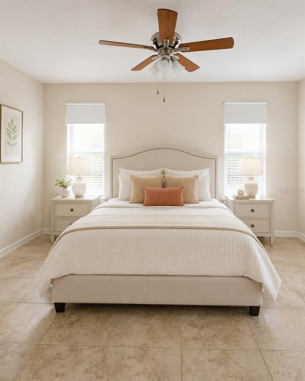 A bedroom features a neutral-toned bed, two nightstands with lamps, and a ceiling fan — 1203 SAXONY CIRCLE UNIT B, PUNTA GORDA, FL