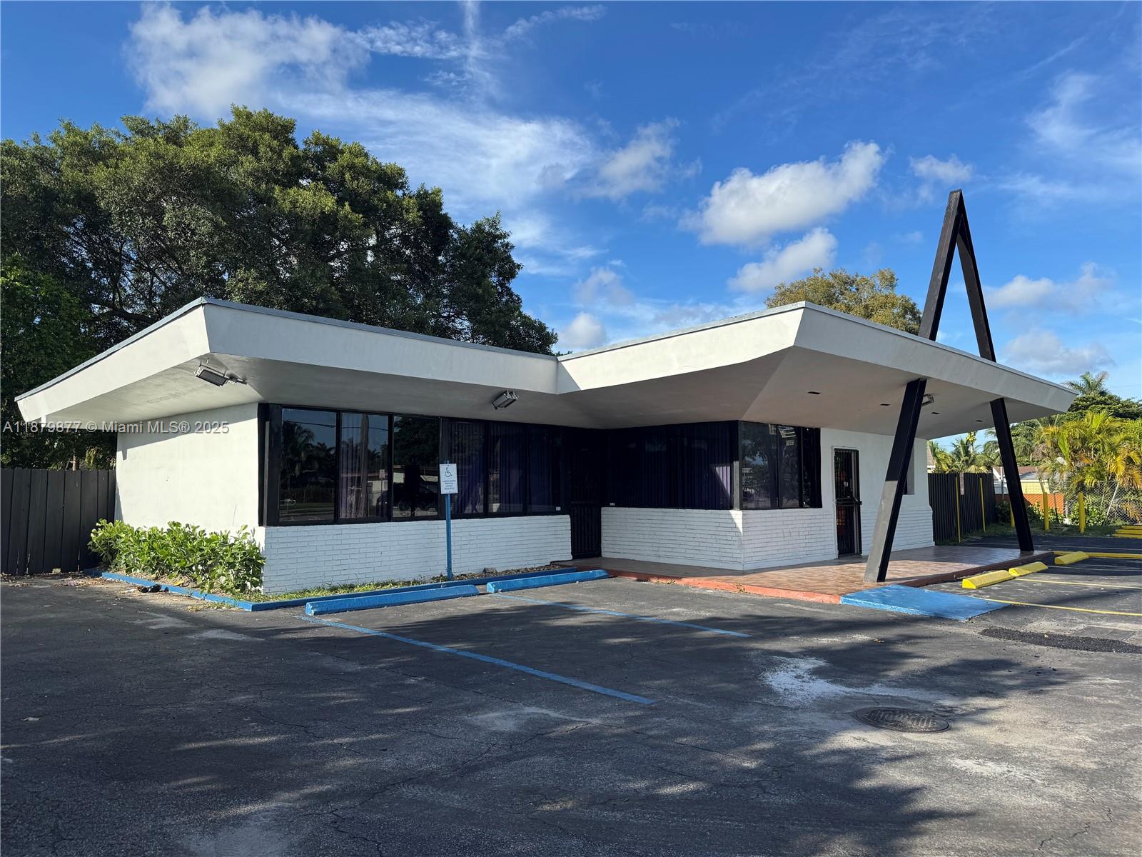 A single-story commercial building features a flat roof with a prominent A-frame support structure — 1605 NW 95th St, Miami FL 33147, MIAMI, FL