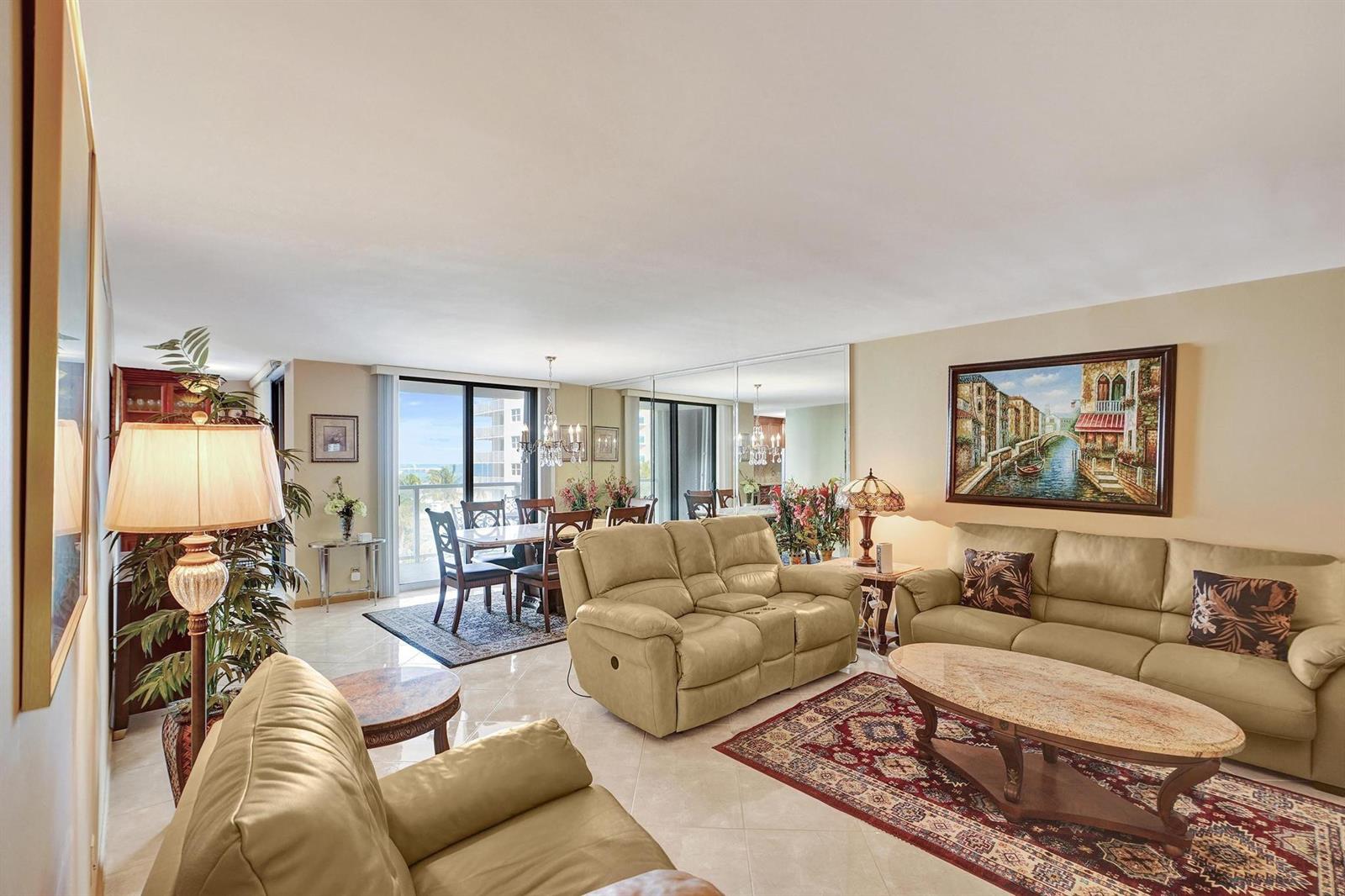 A living and dining area with beige leather furniture, a marble coffee table, and balcony views — 1000 S Ocean Boulevard # 6m, Pompano Beach FL 33062, POMPANO BEACH, FL