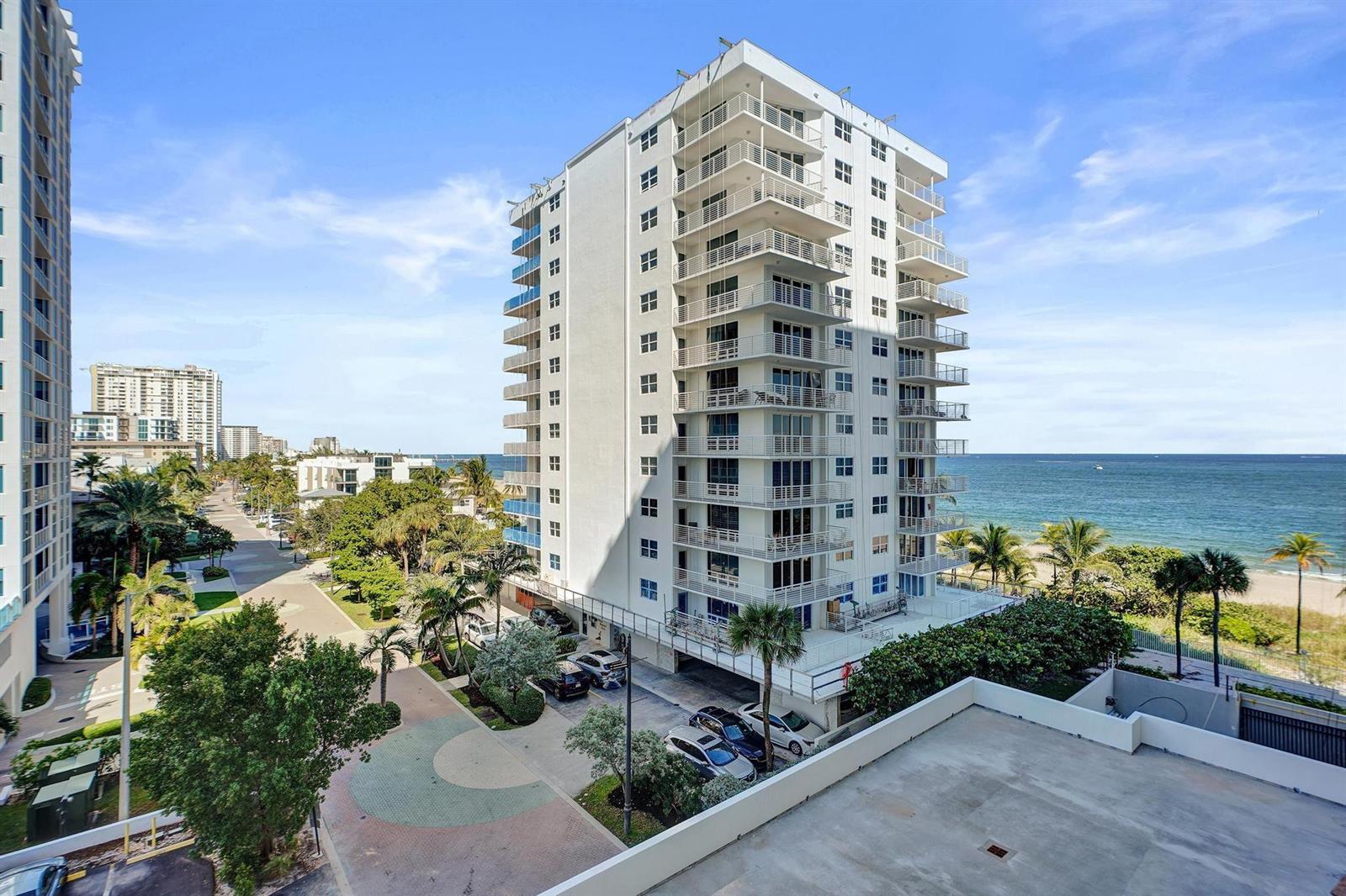 An exterior view of a tall white residential building located next to a beach — 1000 S Ocean Boulevard # 6m, Pompano Beach FL 33062, POMPANO BEACH, FL