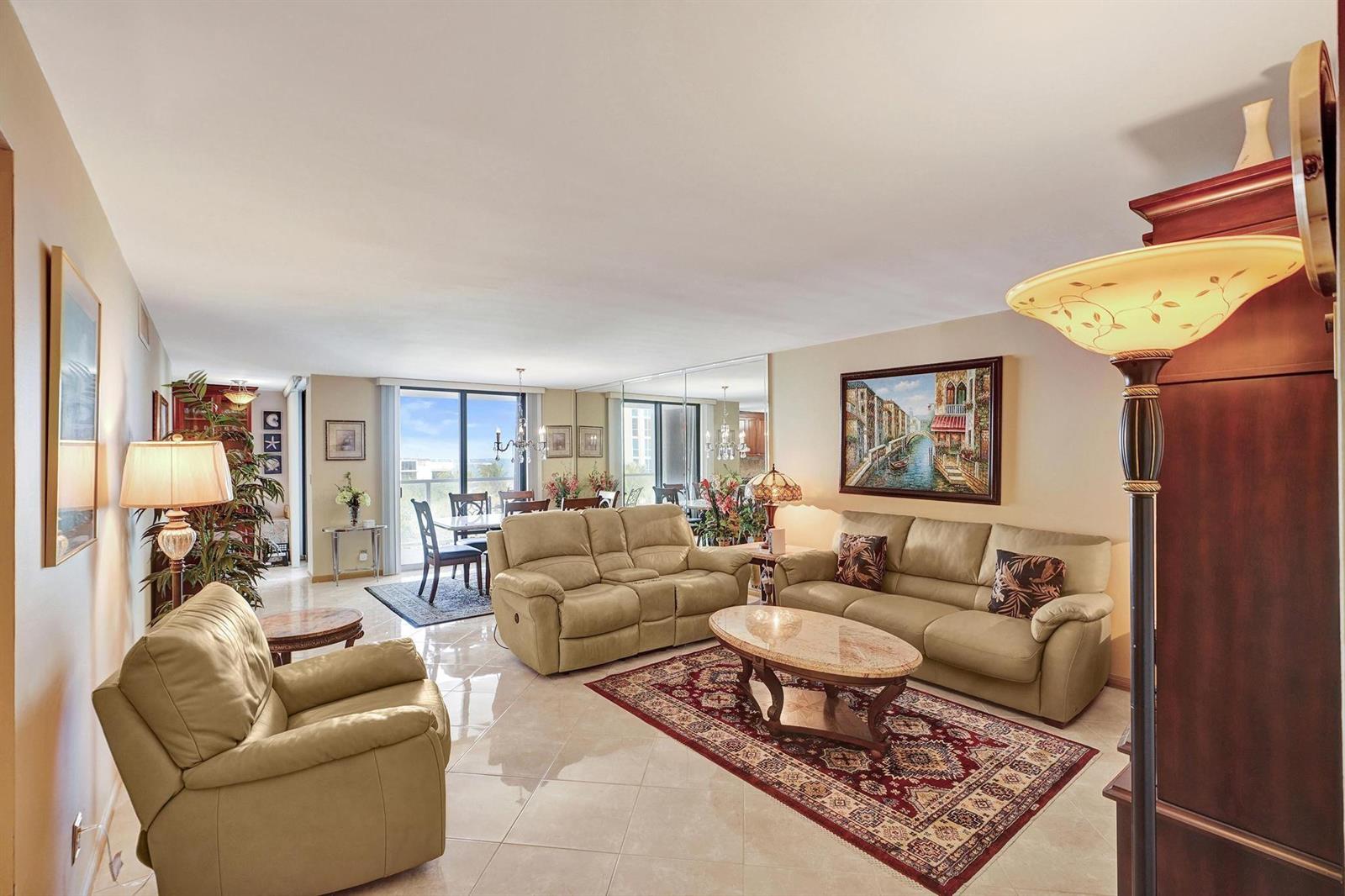 A living room with beige leather furniture, a marble coffee table, and a red area rug — 1000 S Ocean Boulevard # 6m, Pompano Beach FL 33062, POMPANO BEACH, FL