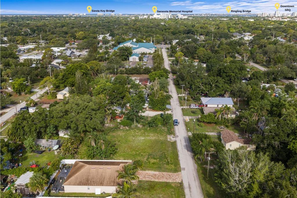 An aerial view shows a residential street with a vacant lot and surrounding houses — 2930 HAWTHORNE STREET, SARASOTA, FL