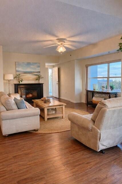 A living room features a fireplace, light-colored furniture, a wooden coffee table, and large windows — 5300 S ATLANTIC AVENUE UNIT 8-401, NEW SMYRNA BEACH, FL