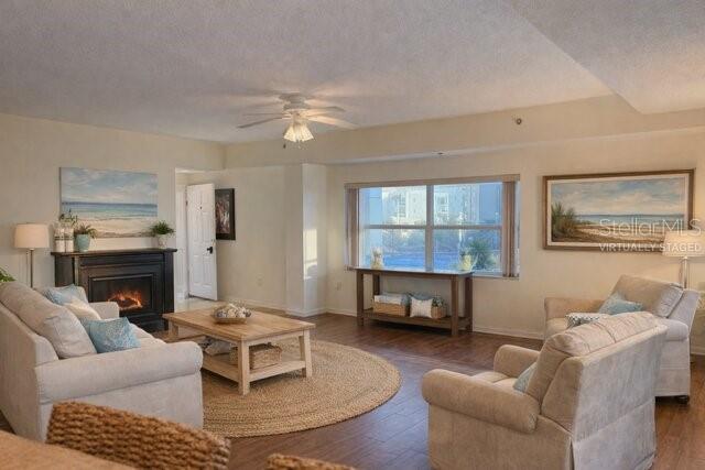 A living room features a fireplace, a coffee table on a rug, and two armchairs — 5300 S ATLANTIC AVENUE UNIT 8-401, NEW SMYRNA BEACH, FL