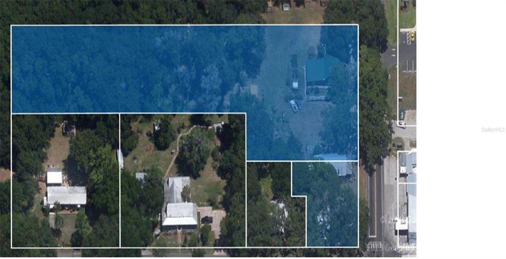 An aerial view shows several adjacent properties with houses and wooded lots outlined in blue — 7698 S FLORIDA AVENUE UNIT 1, FLORAL CITY, FL