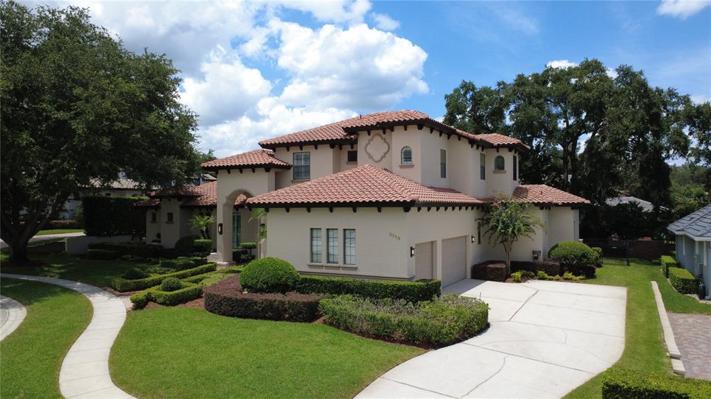 An aerial view of a two-story stucco house with a tile roof and concrete driveway — 3318 SUNSET VIEW COURT, LONGWOOD, FL