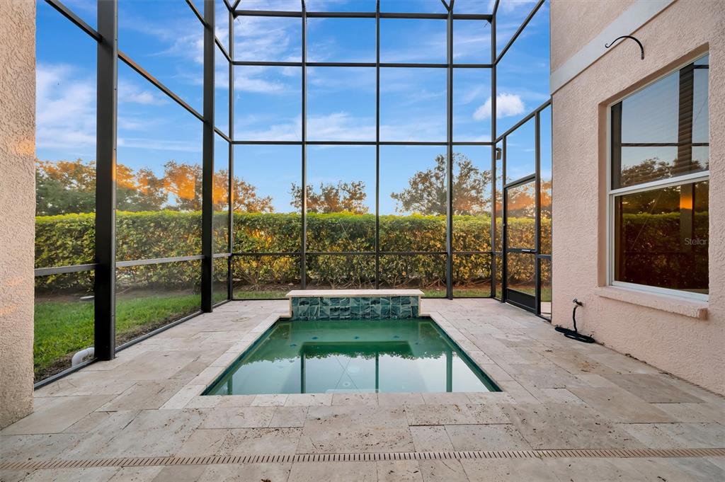 A screened-in patio features a small rectangular pool with a tiled water feature — 4510 MURCIA BOULEVARD UNIT 16, SARASOTA, FL