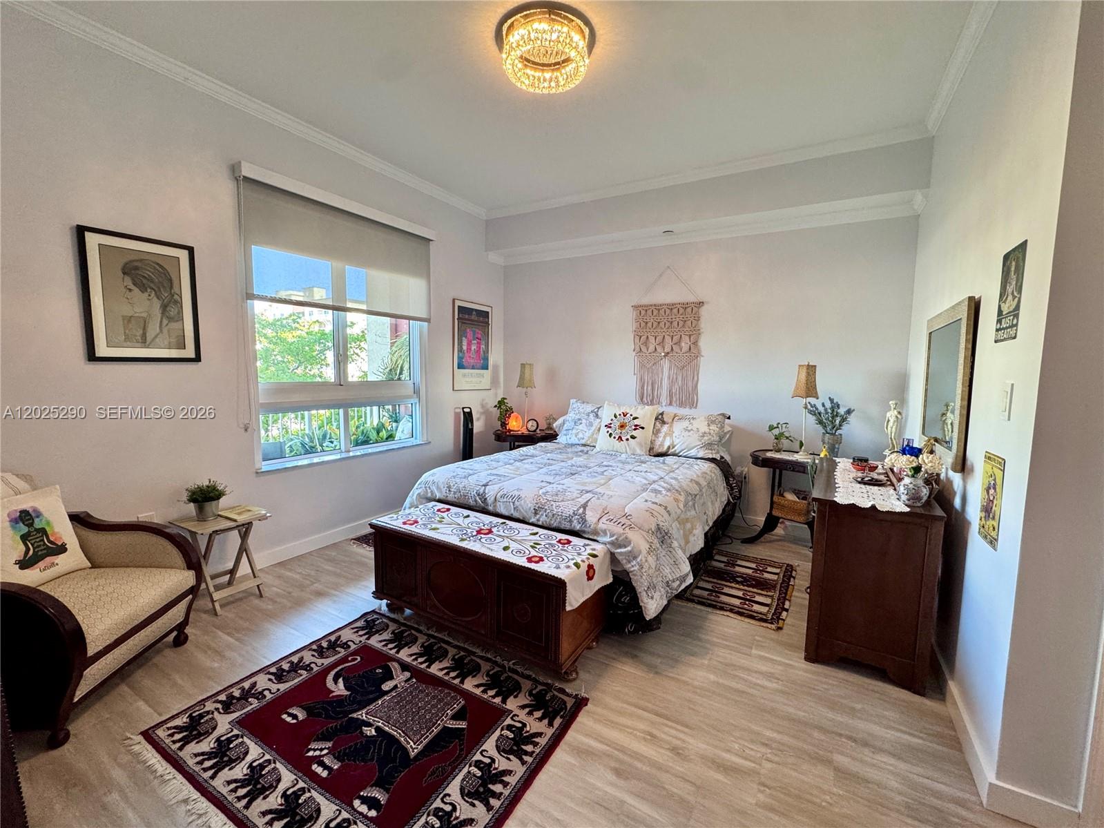 A bedroom features a bed with a patterned quilt, a wooden chest, and an elephant rug — 7355 SW 89th St # 423N, Miami FL 33156, MIAMI, FL