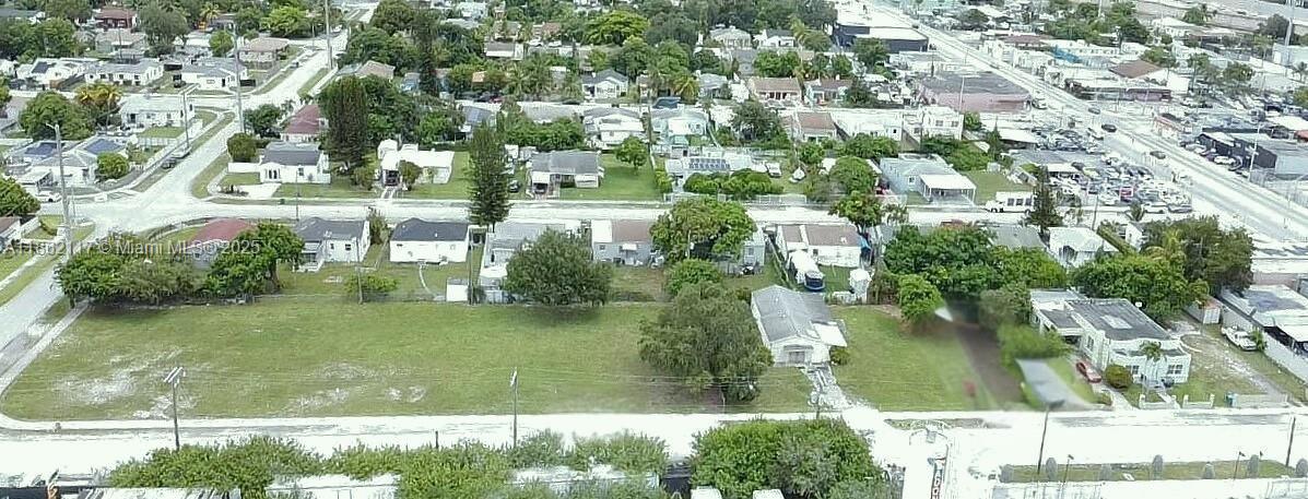An aerial view shows a large, grassy vacant lot adjacent to a single-story residential house — 759 NW 73rd ST, Miami FL 33150, MIAMI, FL