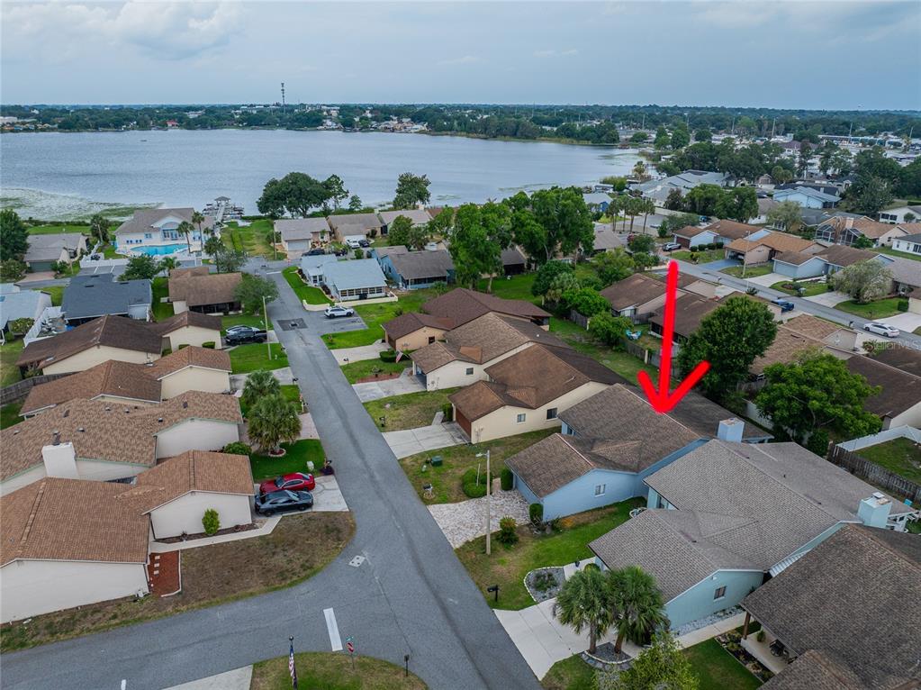 An aerial view shows a light blue house with a brown roof in a neighborhood — 4114 FISHERMANS LANDING, WINTER HAVEN, FL