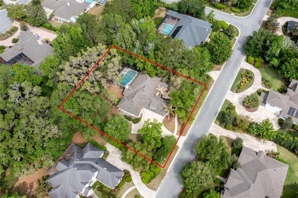 A beige house exterior features a stone facade, double front doors, and a concrete walkway — 3680 SW 86TH STREET, GAINESVILLE, FL