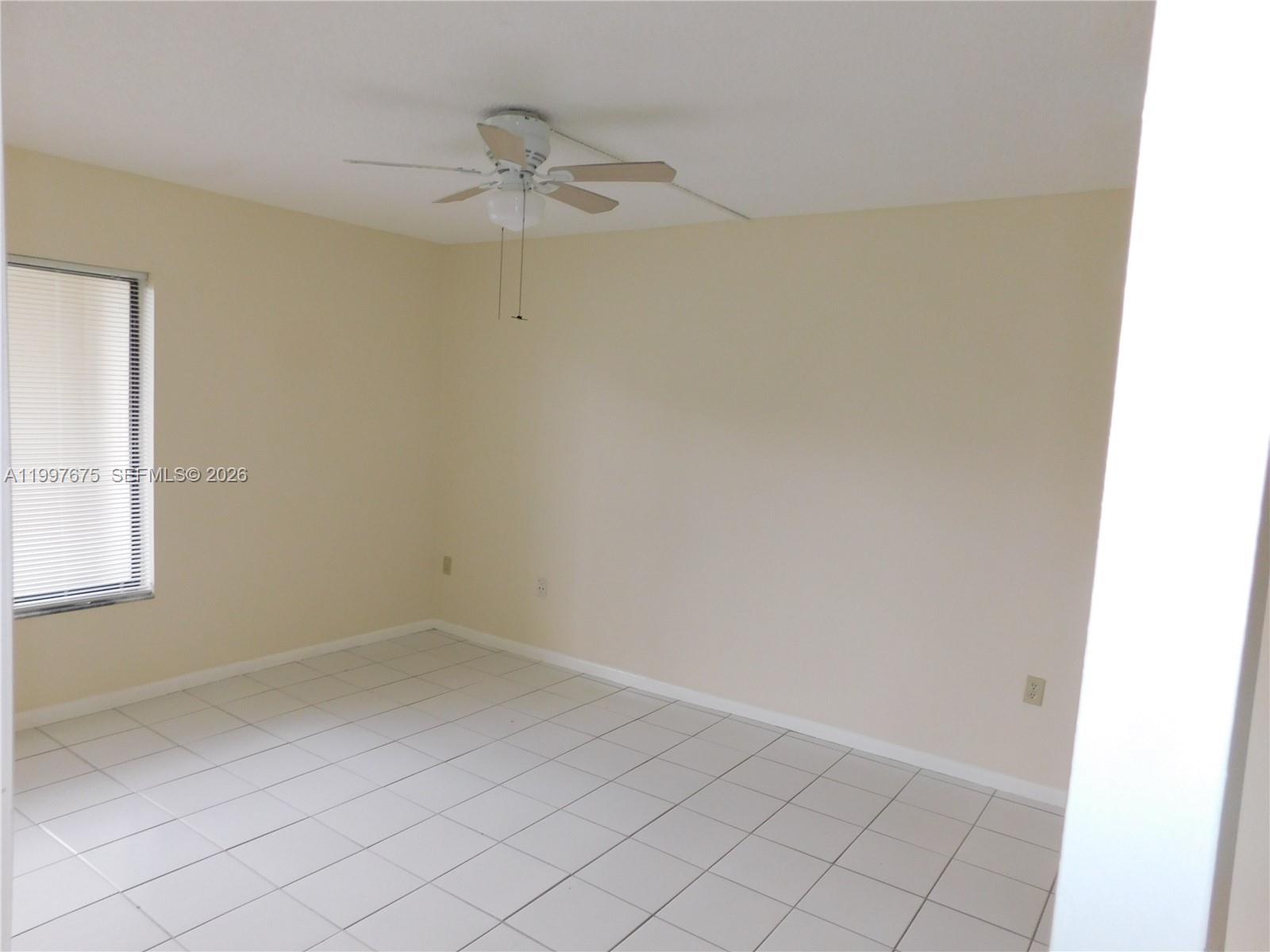 A kitchen features white cabinets, wood-look laminate countertops, a stainless steel refrigerator, and white appliances — 8005 SW 107th Ave # 309, Miami FL 33173, MIAMI, FL