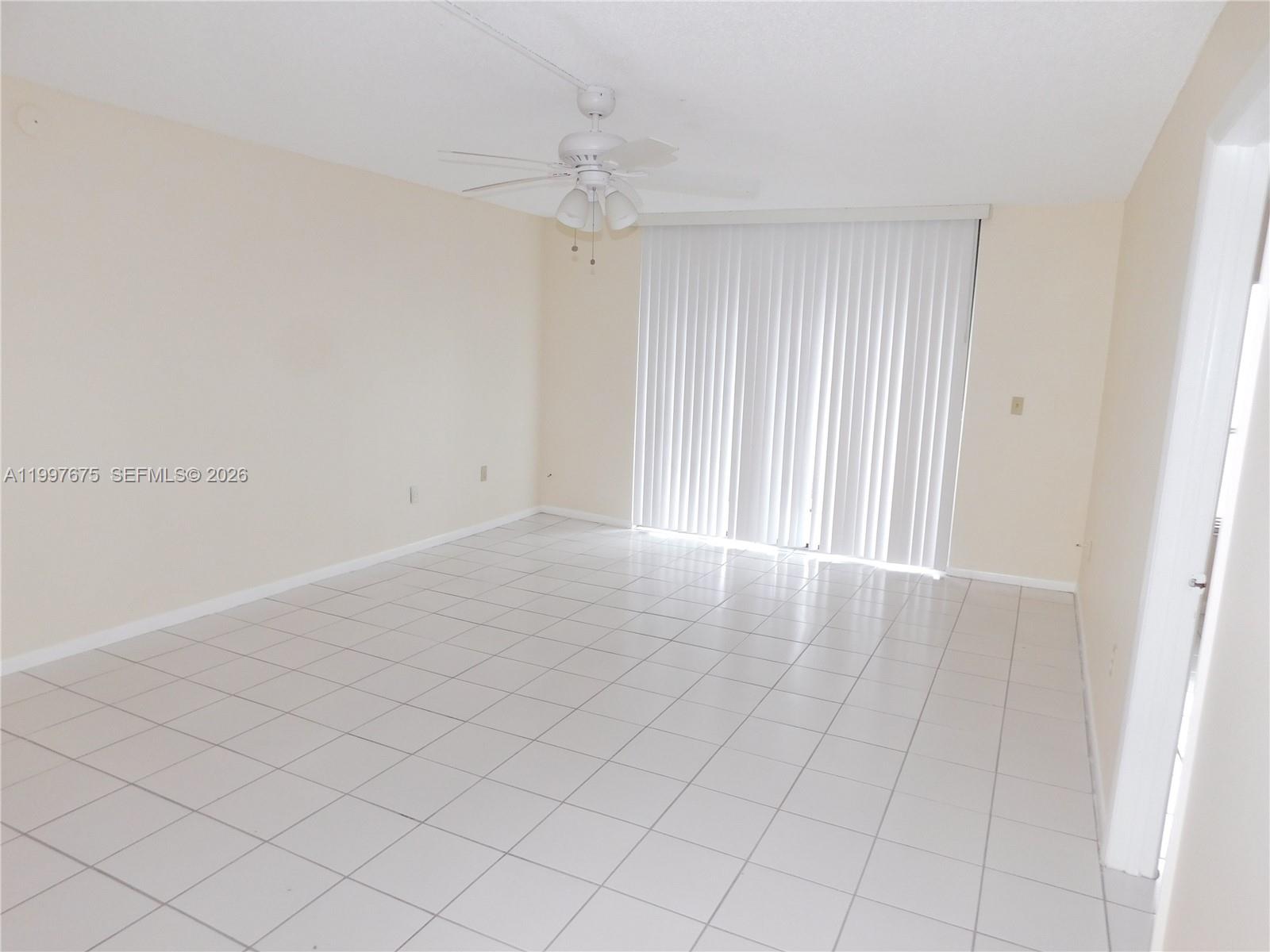 A kitchen features white cabinets, stainless steel appliances, and wood-look laminate countertops — 8005 SW 107th Ave # 309, Miami FL 33173, MIAMI, FL