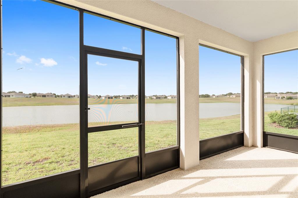A single-story house with a beige stucco exterior, stone accents, and a two-car garage — 9358 SW 60TH TERRACE ROAD, OCALA, FL