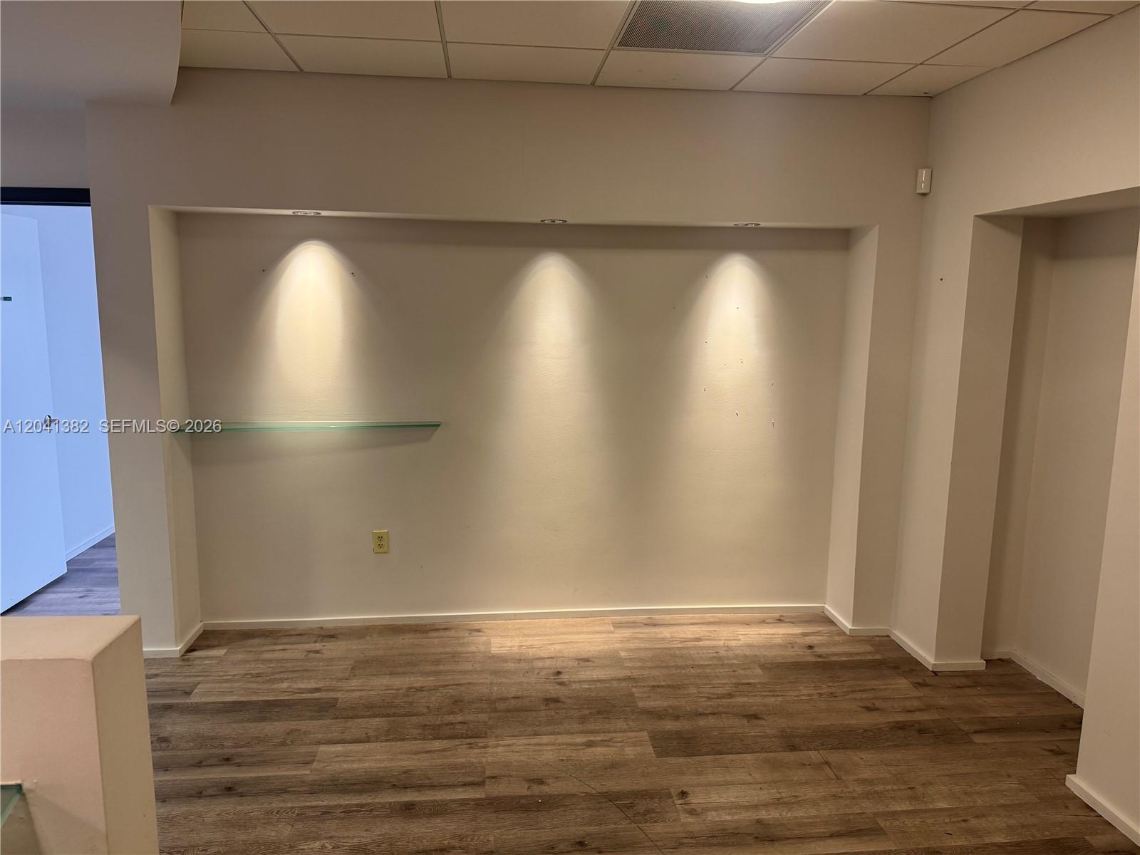 An alcove with recessed lighting and a glass shelf features wood-look flooring — 8700 W Flagler St # 200, Miami FL 33174, MIAMI, FL