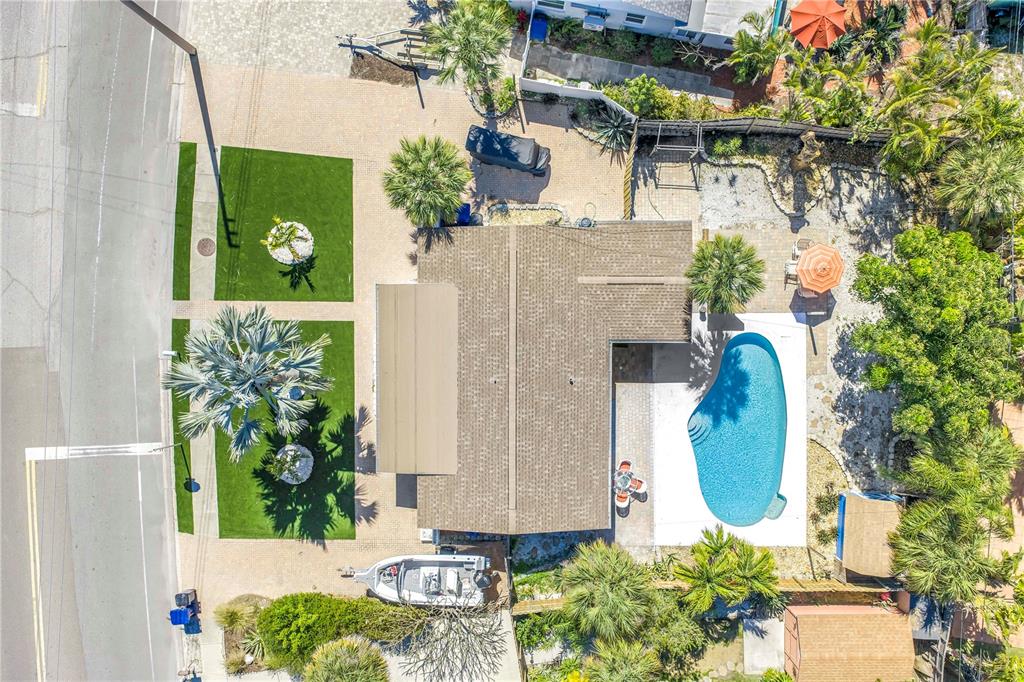 An aerial view shows a house with a pool, patio, and driveway on a lot — 6892 GULF WINDS DRIVE UNIT 1, ST PETE BEACH, FL