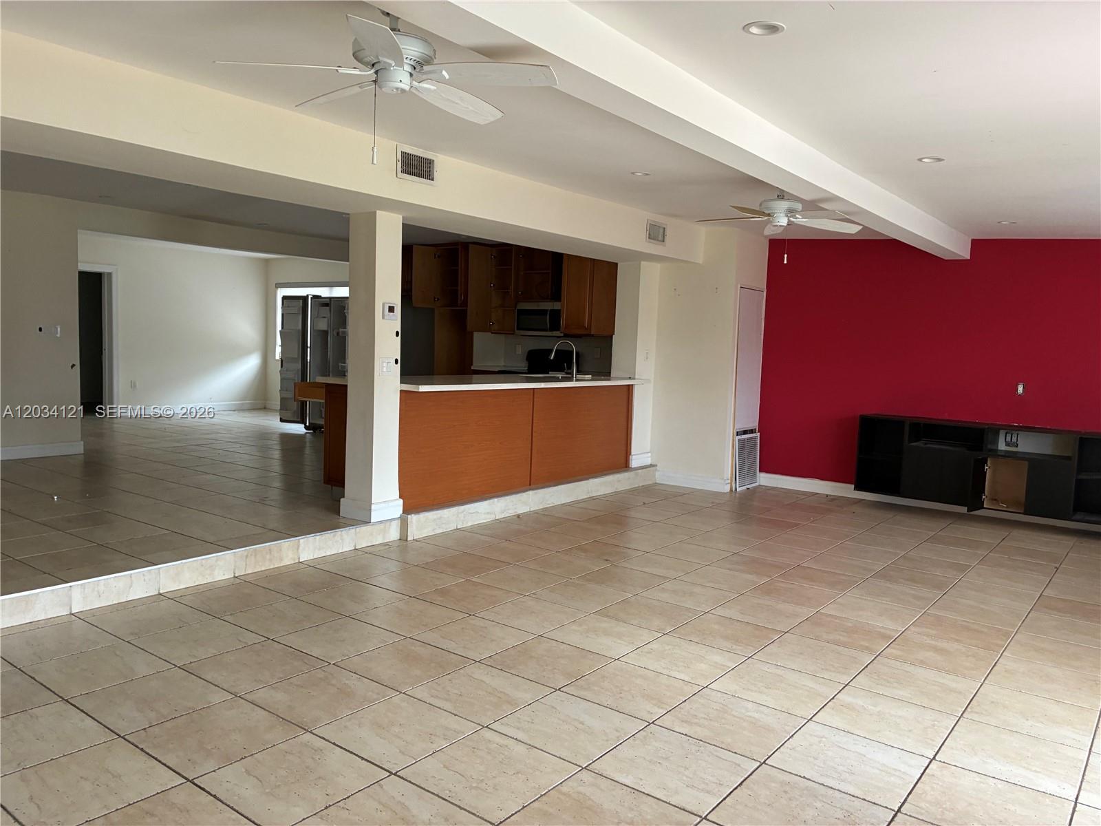 The exterior of a house features a brown front door, horizontal windows, and a tiled entryway — 18715 NE 18th Ave, Miami FL 33179, MIAMI, FL