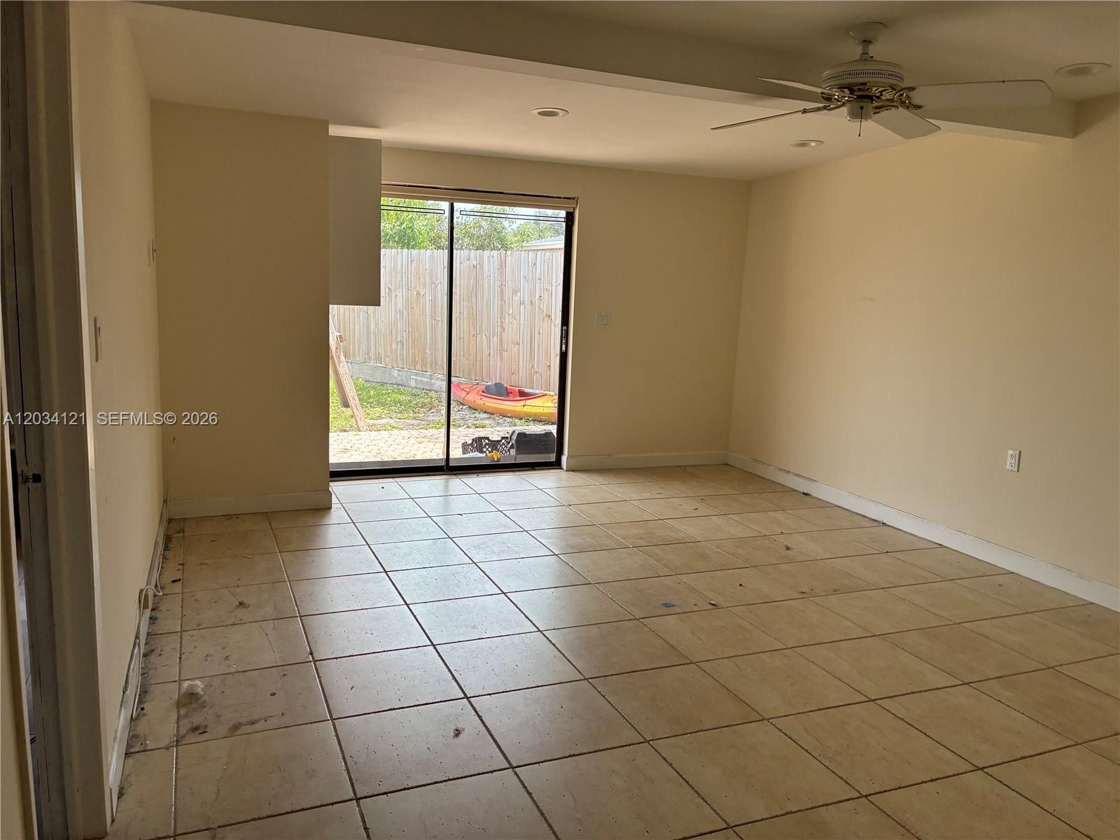 A single-story house with a tan exterior, white trim, and a palm tree in front — 18715 NE 18th Ave, Miami FL 33179, MIAMI, FL