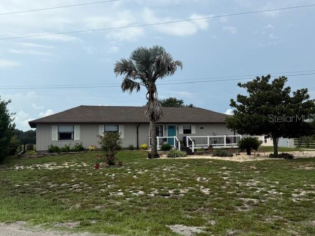 A single-story house with a brown roof, light siding, and a front deck — 5015 TWIN LAKES LANE, BARTOW, FL