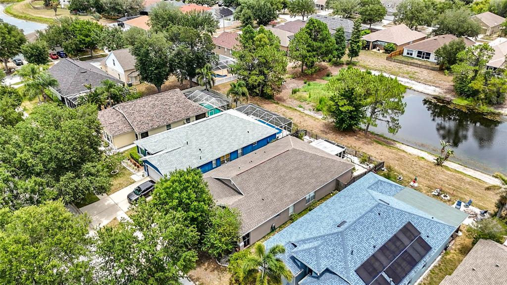 An aerial view shows several suburban houses with swimming pools and a nearby pond — 6630 CAMBRIDGE PARK DRIVE, APOLLO BEACH, FL