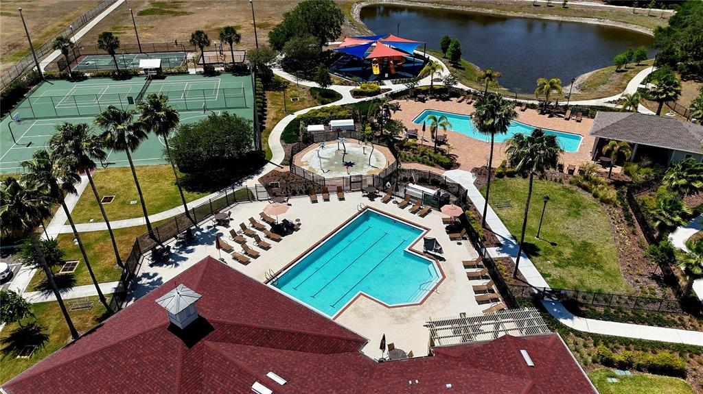 An aerial view shows a community recreation area with two swimming pools, tennis courts, and playground — 6630 CAMBRIDGE PARK DRIVE, APOLLO BEACH, FL
