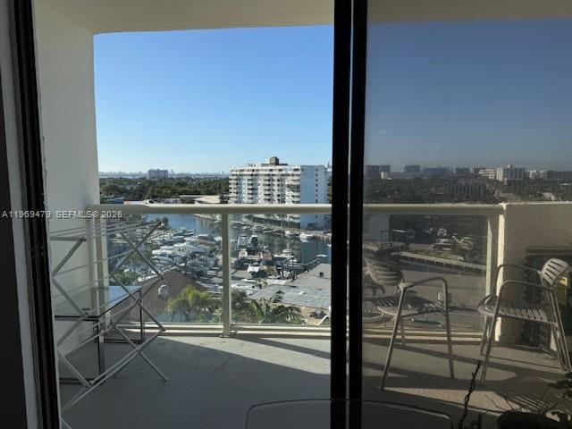 A balcony view overlooks a marina and a multi-story building under a clear blue sky — 13499 Biscayne Blvd # 902, North Miami FL 33181, NORTH MIAMI, FL