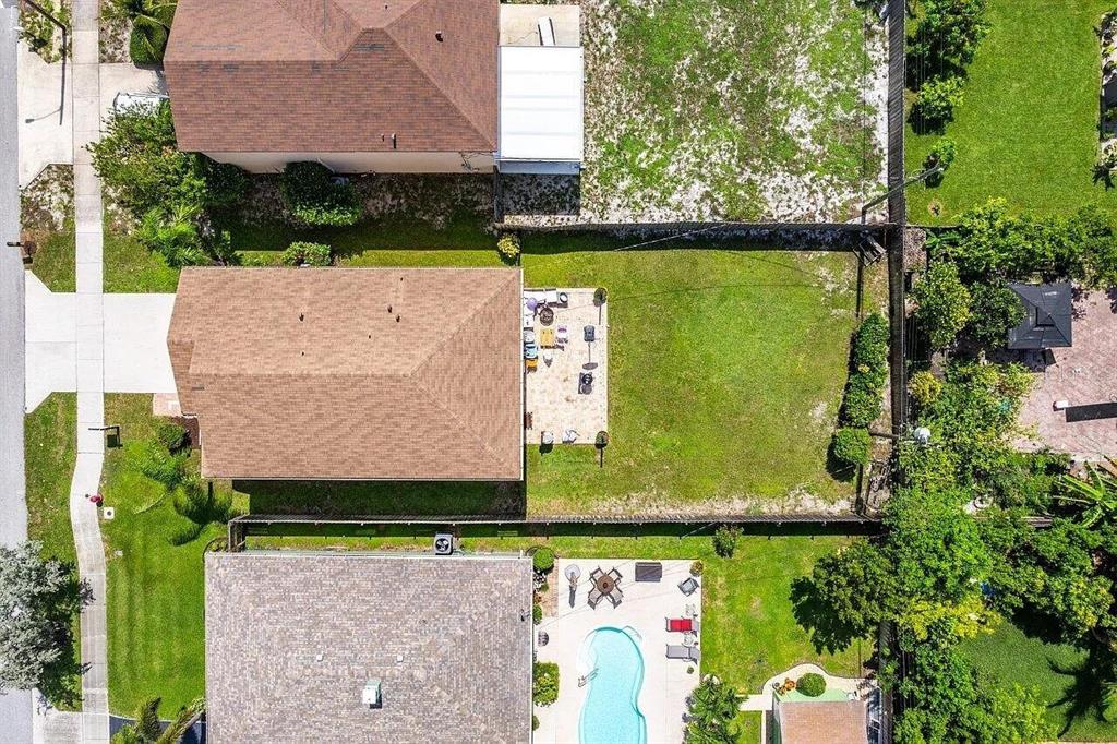 An aerial view shows three residential houses with backyards, including one with a swimming pool — 119 SW 2ND AVENUE, BOYNTON BEACH, FL